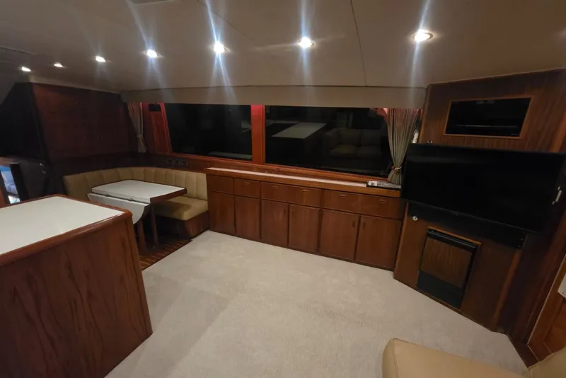 Slide: The Image of Interior of 1984 Bertram 54 Convertible yacht with wood cabinetry and seating area. - 70
