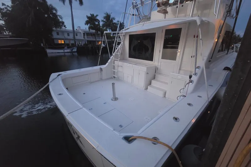 Slide: The Image of 1984 Bertram 54 Convertible yacht docked at marina during twilight. - 88