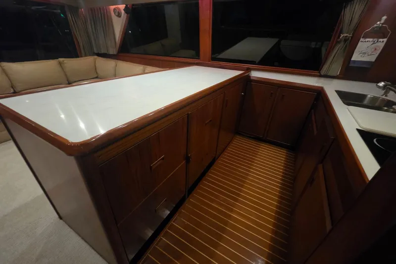 Slide: The Image of Interior of 1984 Bertram 54 Convertible yacht with wooden cabinetry and modern kitchen amenities. - 93