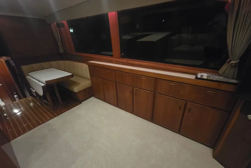 Slide: The Image of Interior of 1984 Bertram 54 Convertible yacht with wood cabinets and dining area. - 71