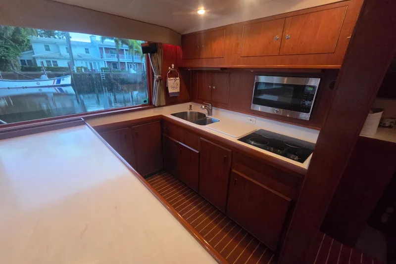 Slide: The Image of Interior of 1984 Bertram 54 Convertible yacht kitchen with wooden cabinets and modern appliances. - 41