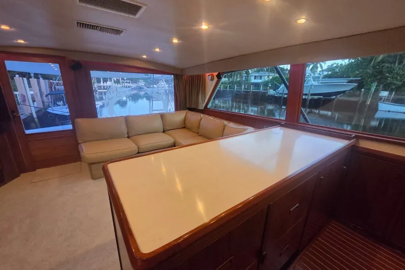 Slide: The Image of Interior of 1984 Bertram 54 Convertible yacht with spacious seating and large windows. - 39