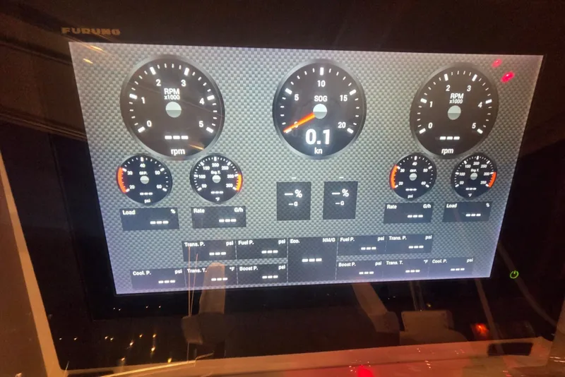 Slide: The Image of Instrument panel of a 1984 Bertram 54 Convertible boat, displaying RPM and speed gauges. - 103