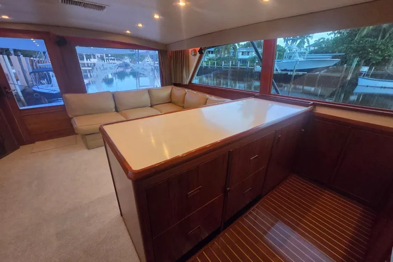 Slide: The Image of Interior of 1984 Bertram 54 Convertible yacht with elegant wood cabinetry and spacious seating area. - 38