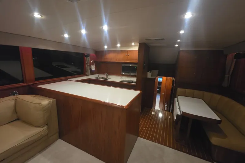 Slide: The Image of Interior of a 1984 Bertram 54 Convertible yacht with modern kitchen and seating area. - 98