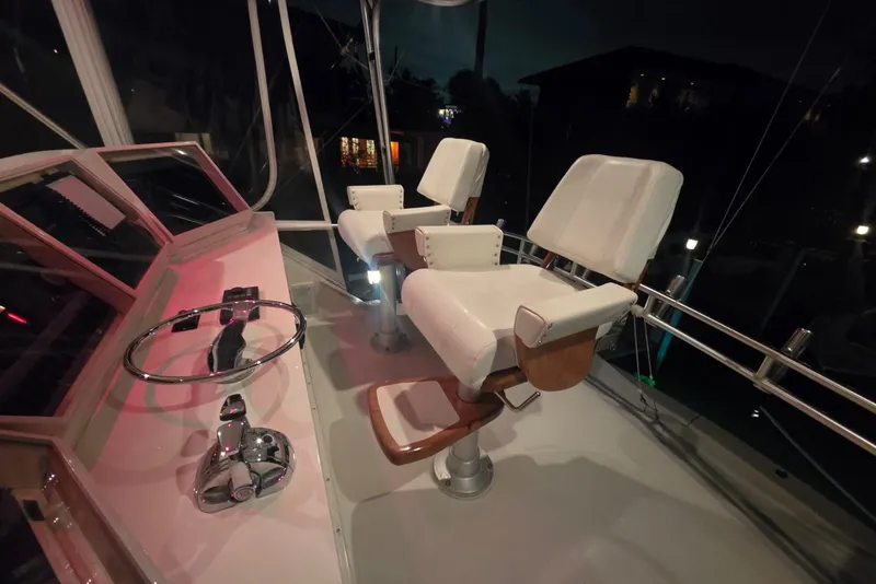 Slide: The Image of Interior of 1984 Bertram 54 Convertible yacht with helm and white captain chairs. - 107