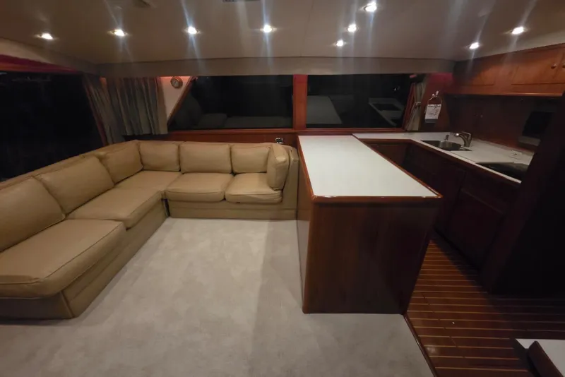 Slide: The Image of Interior of 1984 Bertram 54 Convertible yacht with beige sofa and wooden cabinetry. - 100