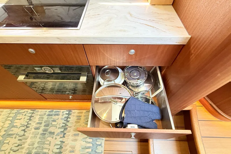 Slide: The Image of Kitchen drawer in 2021 Elling E6 yacht with cookware and oven mitt. - 49