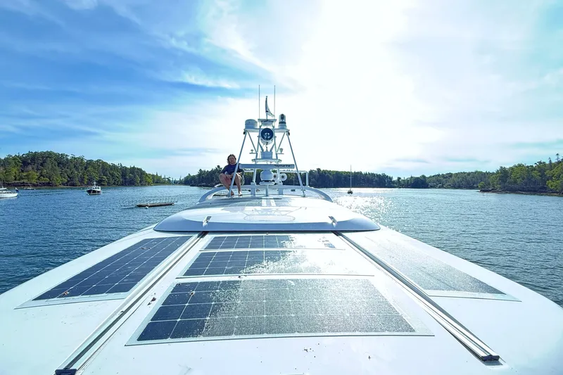 Slide: The Image of 2021 Elling E6 yacht with solar panels cruising on a scenic lake. - 109