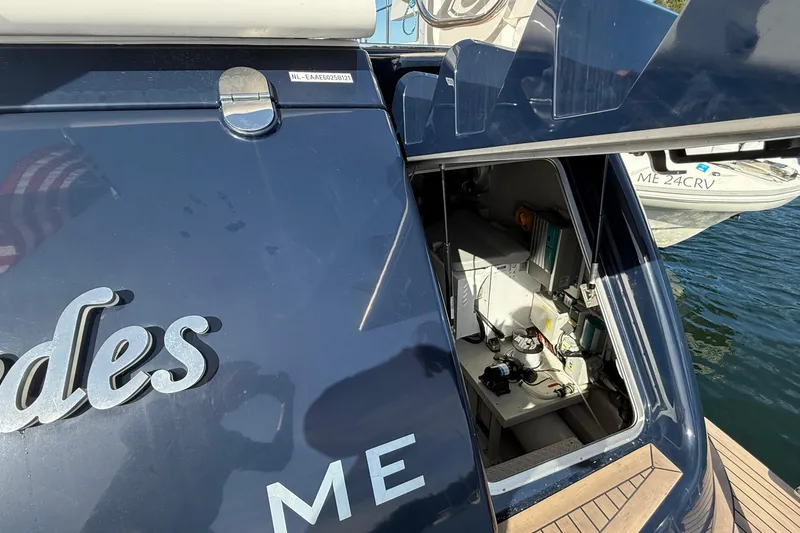 Slide: The Image of 2021 Elling E6 yacht with open hatch revealing interior equipment, docked by the water. - 86