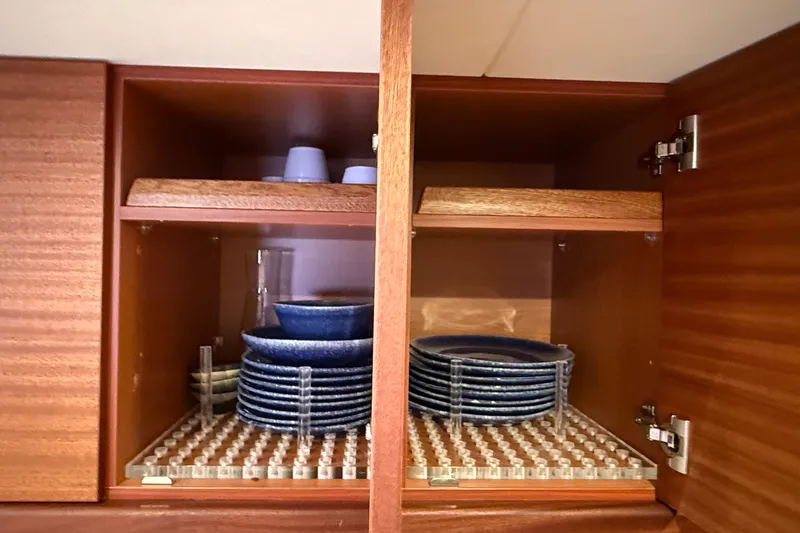 Slide: The Image of Wooden cabinet with neatly stacked blue dishes and cups, Elling E6 2021 model. - 59