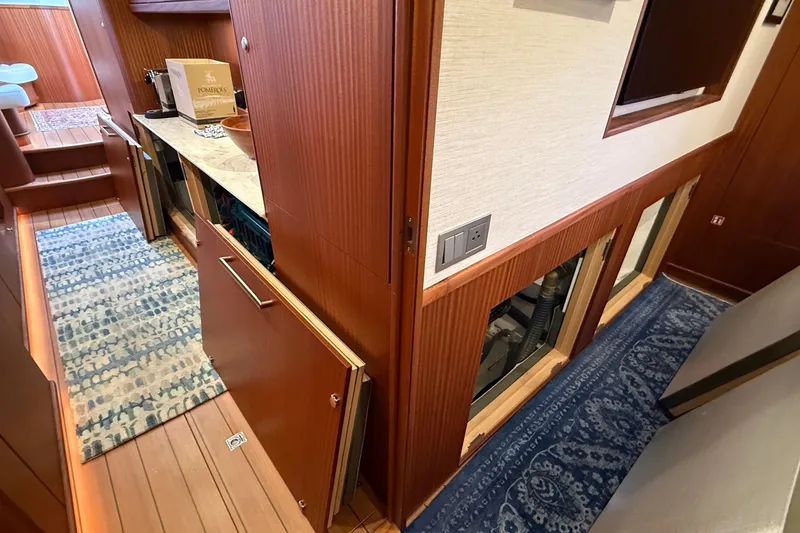 Slide: The Image of Interior of 2021 Elling E6 yacht with wooden cabinetry and patterned rugs. - 74