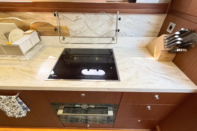 Slide: The Image of Modern kitchen in 2021 Elling E6 yacht with stove, marble countertop, and knife set. - 45