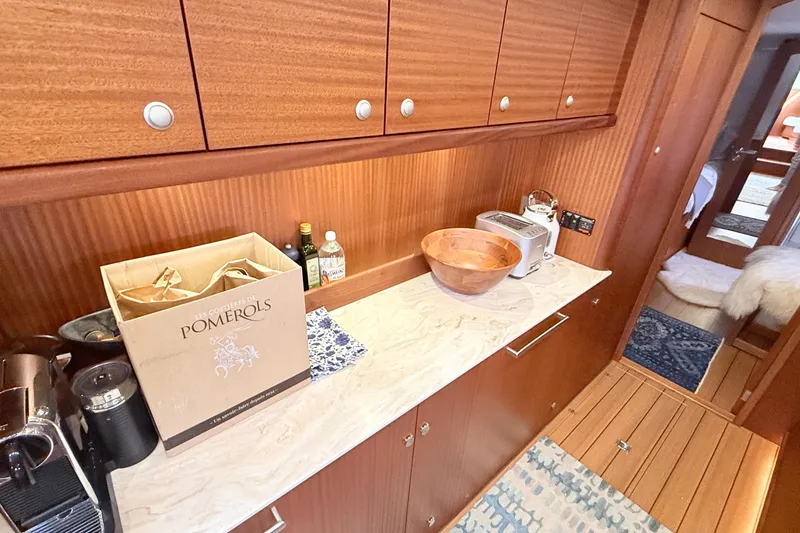 Slide: The Image of Luxurious 2021 Elling E6 yacht interior with wooden cabinetry and modern kitchen appliances. - 57