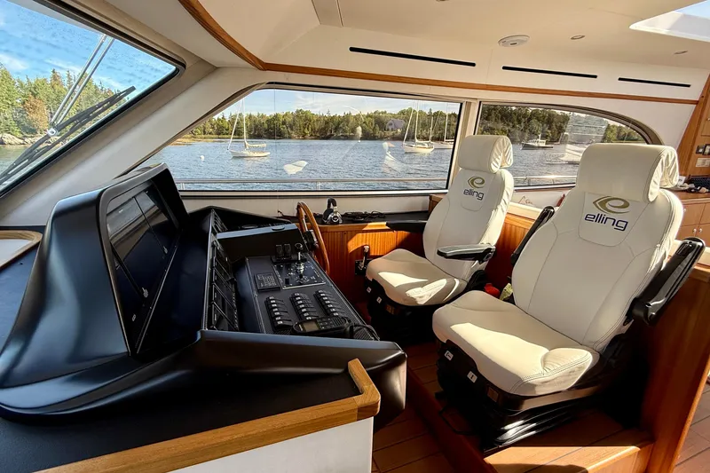Slide: The Image of Interior of 2021 Elling E6 yacht with luxury seating and control panel, scenic water view. - 28