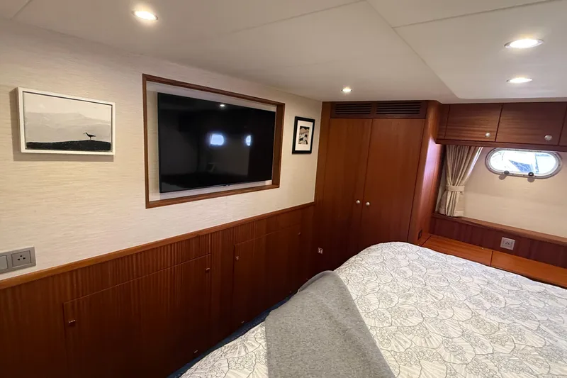 Slide: The Image of Luxurious 2021 Elling E6 yacht cabin with wood paneling, TV, and porthole window. - 62