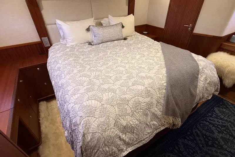 Slide: The Image of Luxurious bedroom interior on a 2021 Elling E6 yacht, featuring elegant bedding and wood accents. - 61