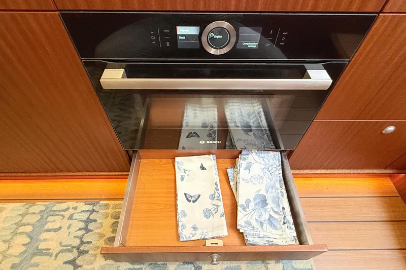 Slide: The Image of Modern Bosch oven in Elling E6 yacht kitchen, 2021, with floral napkins in drawer. - 48