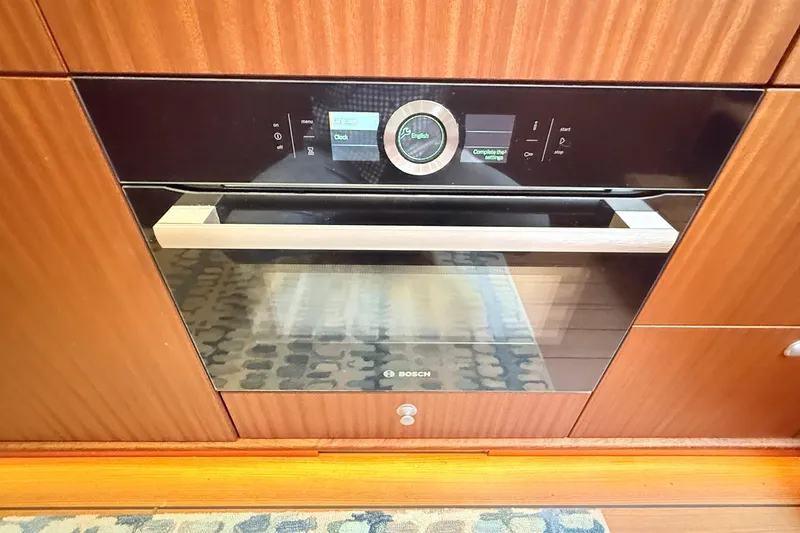 Slide: The Image of Modern Bosch oven in a 2021 Elling E6 yacht kitchen, featuring sleek design and digital controls. - 47