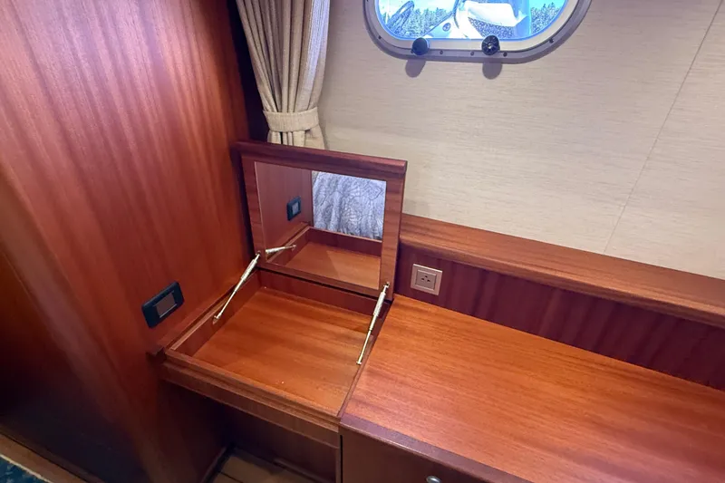 Slide: The Image of Luxury wooden vanity area on 2021 Elling E6 yacht with mirror and porthole. - 72