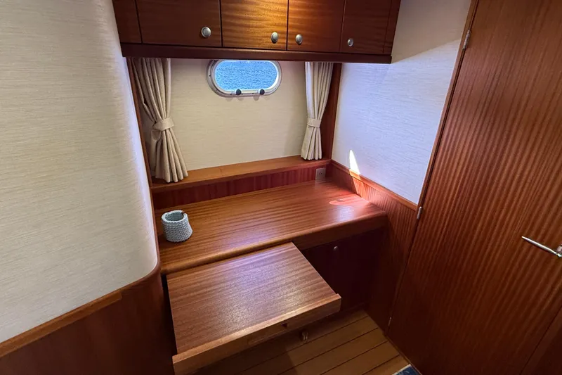 Slide: The Image of Cozy cabin interior of 2021 Elling E6 yacht with wooden desk and porthole. - 70