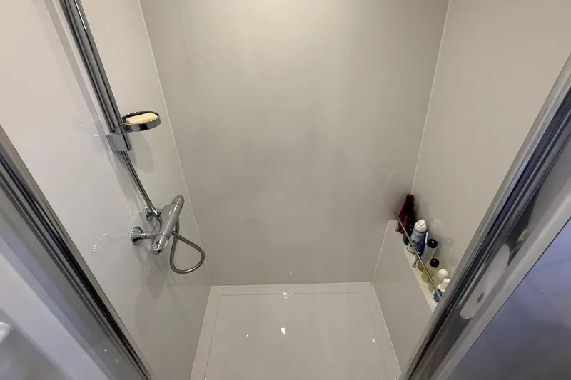 Slide: The Image of Modern shower area in 2021 Elling E6 yacht, featuring chrome fixtures and toiletries. - 67