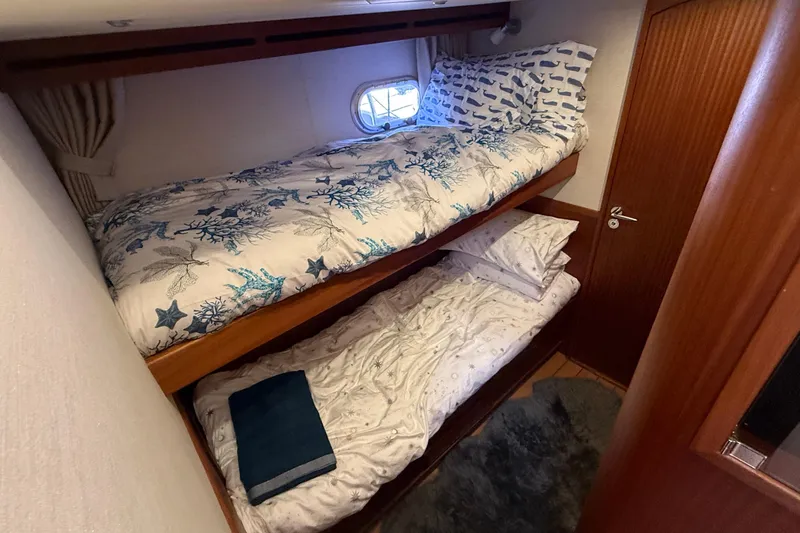 Slide: The Image of Bunk beds in 2021 Elling E6 yacht cabin with nautical-themed bedding. - 38