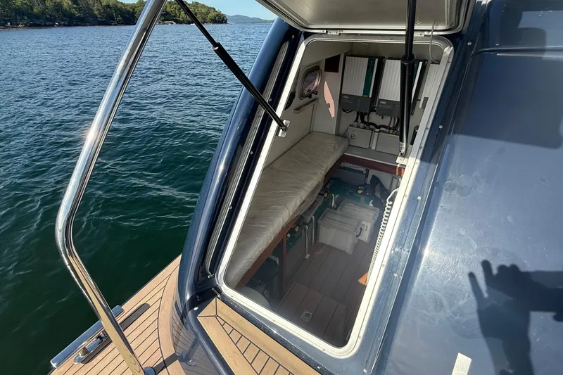 Slide: The Image of 2021 Elling E6 yacht interior with open hatch, showing storage and equipment. - 103