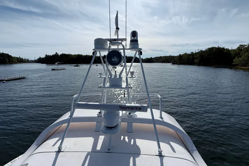 Slide: The Image of Elling E6 2021 yacht navigating a serene waterway under a clear sky. - 110