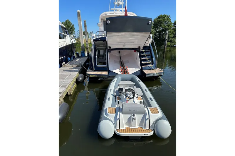 Slide: The Image of Luxury 2021 Elling E6 yacht with tender boat docked at marina. - 96