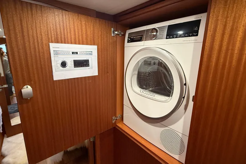 Slide: The Image of Laundry area inside 2021 Elling E6 yacht with modern washer-dryer unit. - 55