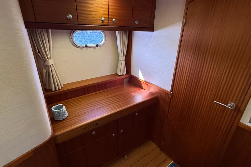 Slide: The Image of Luxurious wooden interior of 2021 Elling E6 yacht cabin with window and storage. - 69