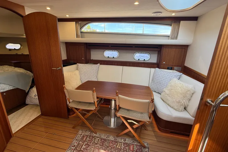 Slide: The Image of Luxurious interior of 2021 Elling E6 yacht with cozy seating and elegant wood finish. - 34