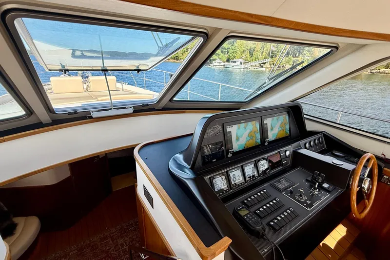 Slide: The Image of 2021 Elling E6 yacht cockpit with navigation screens and wooden steering wheel. - 30