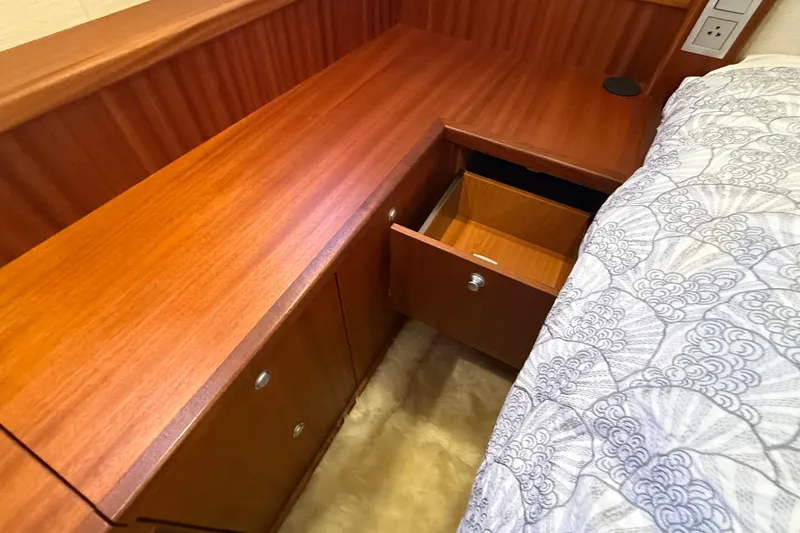 Slide: The Image of Wooden interior of 2021 Elling E6 yacht with open drawer and patterned bedding. - 73