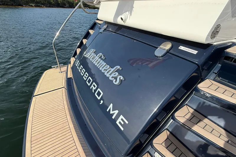 Slide: The Image of 2021 Elling E6 yacht "Archimedes" docked in Islesboro, ME, with wooden deck details. - 85