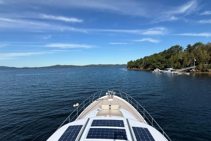 Slide: The Image of Bow view of 2021 Elling E6 yacht with solar panels, cruising on a serene lake. - 112