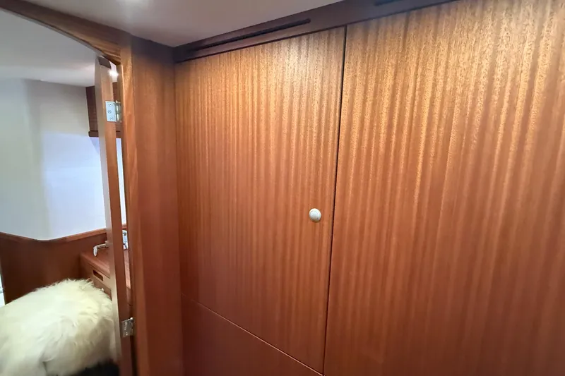 Slide: The Image of Interior of 2021 Elling E6 yacht with wooden paneling and cozy furnishings. - 52