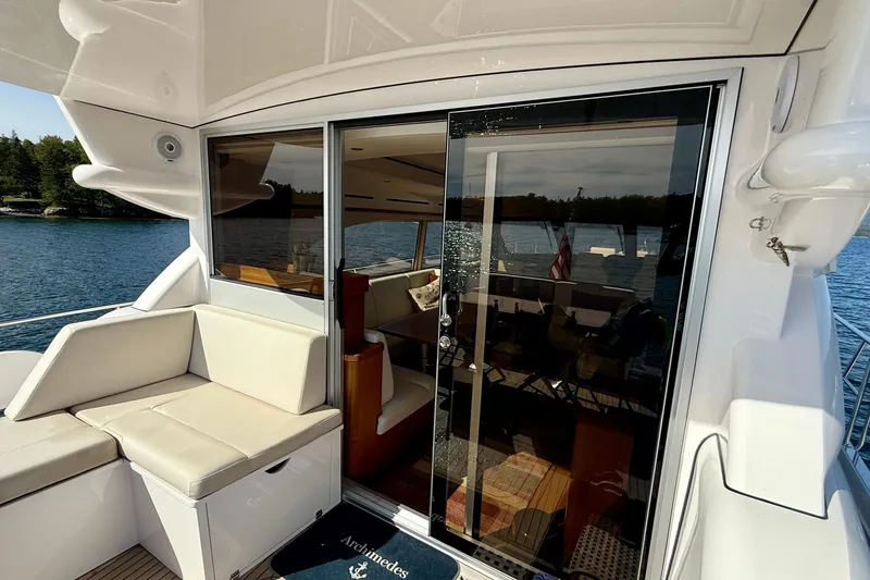 Slide: The Image of Luxury yacht Elling E6 2021 with elegant seating and glass doors overlooking serene waters. - 16