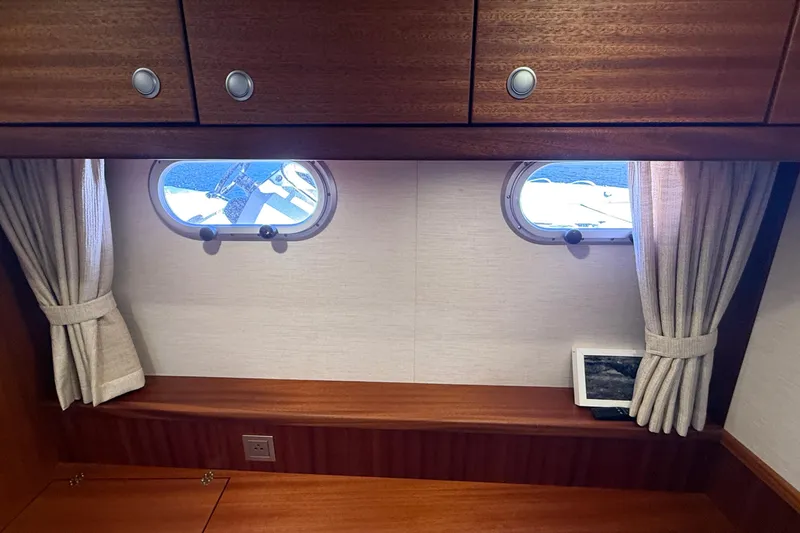 Slide: The Image of Interior of 2021 Elling E6 yacht with wooden cabinets and porthole windows. - 71
