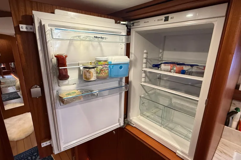 Slide: The Image of Open Miele refrigerator in 2021 Elling E6 yacht, showcasing organized interior storage. - 53