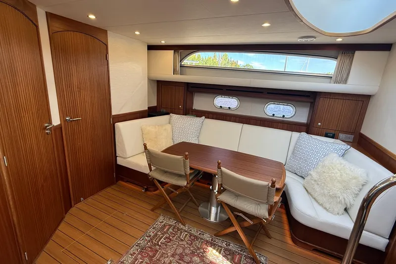 Slide: The Image of Luxurious interior of 2021 Elling E6 yacht with wooden accents and cozy seating area. - 35