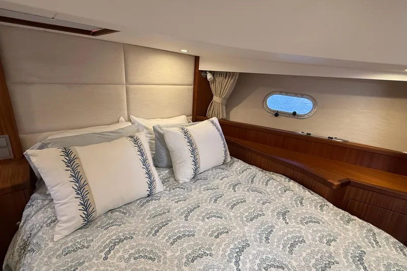 Slide: The Image of Luxurious cabin interior of 2021 Elling E6 yacht with elegant bedding and porthole view. - 78