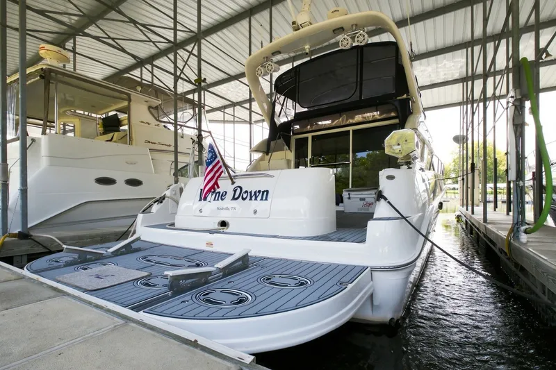 Slide: The Image of 2003 Sea Ray 450 Express Bridge yacht docked in a covered marina. - 26