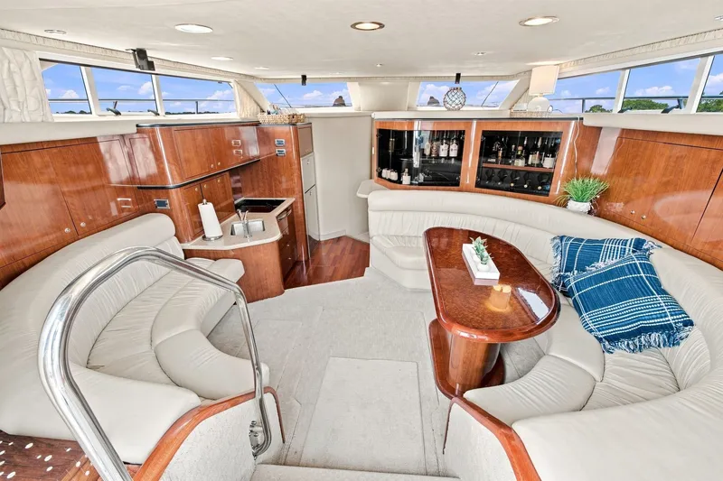 Slide: The Image of Luxurious interior of 2003 Sea Ray 450 Express Bridge yacht with elegant seating and wood finishes. - 45