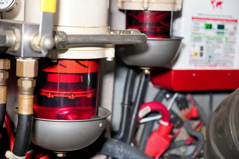 Slide: The Image of Engine room of 2003 Sea Ray 450 Express Bridge with fuel filters and wiring. - 92