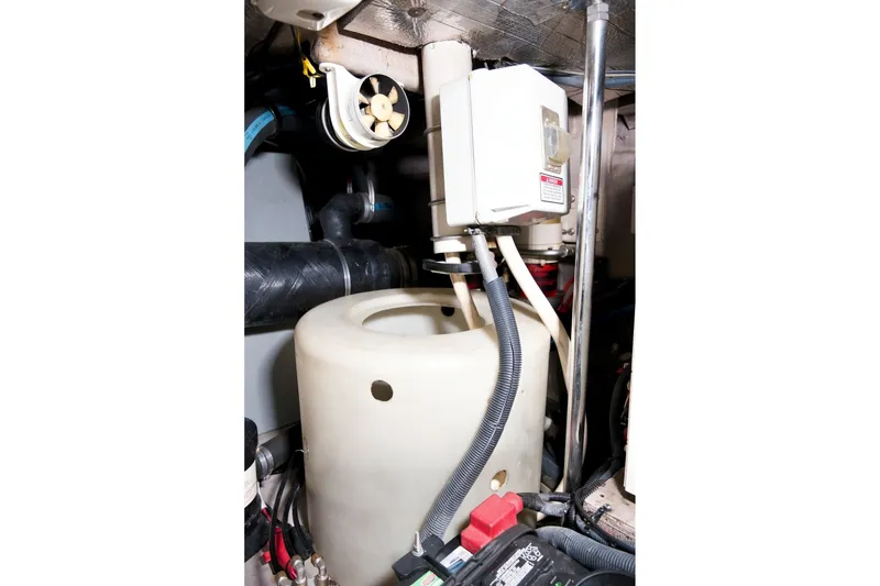 Slide: The Image of Engine room of 2003 Sea Ray 450 Express Bridge with mechanical components. - 87
