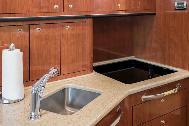 Slide: The Image of Luxurious kitchen area in 2003 Sea Ray 450 Express Bridge yacht with wood cabinetry. - 57