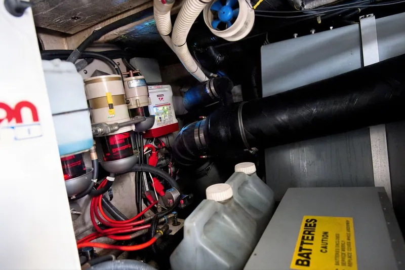 Slide: The Image of Engine room of 2003 Sea Ray 450 Express Bridge with batteries and wiring. - 88