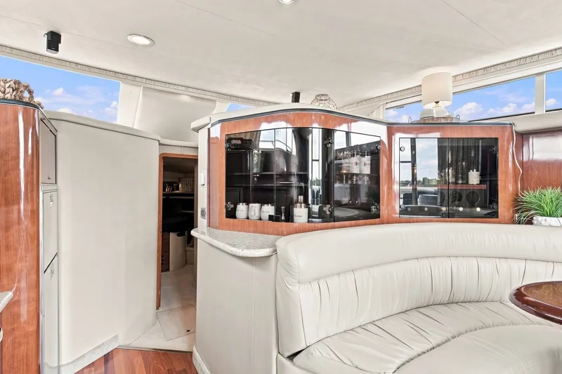 Slide: The Image of Luxurious interior of 2003 Sea Ray 450 Express Bridge yacht with elegant seating and cabinetry. - 47